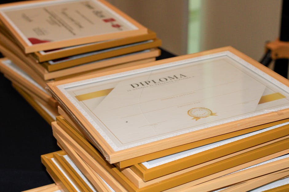 A stack of elegant framed diplomas prepared for an academic ceremony.