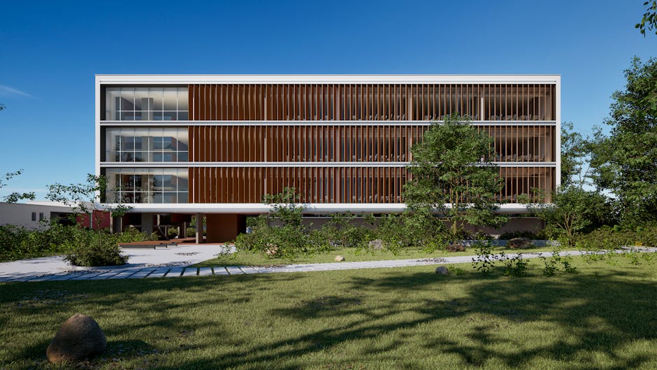 Contemporary building surrounded by greenery and park-like landscape under a clear blue sky.
