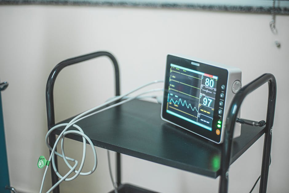 Medical equipment showing heart rate on screen in hospital room.
