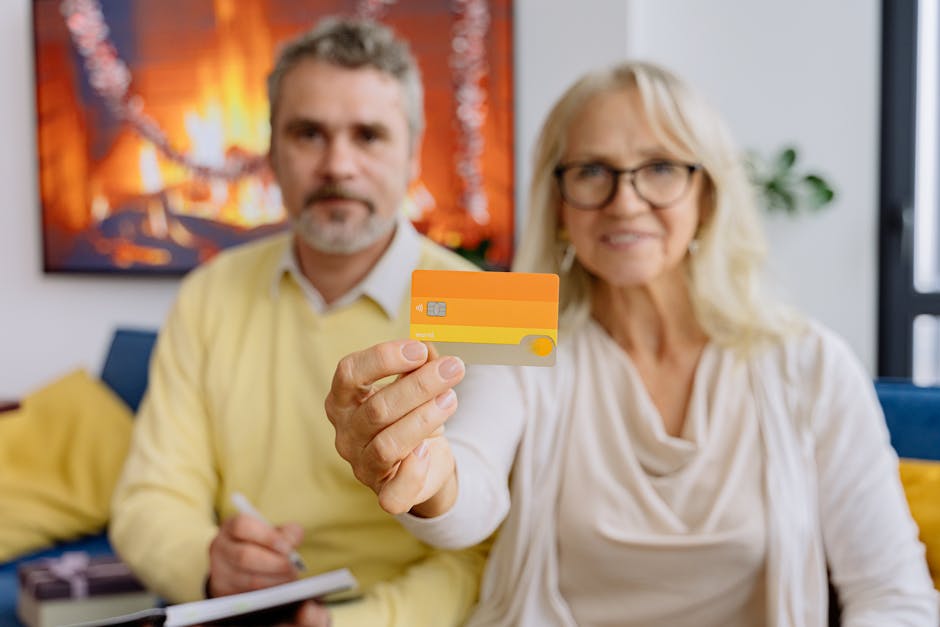 An elderly couple in a warm living room holding a credit card, symbolizing modern banking.